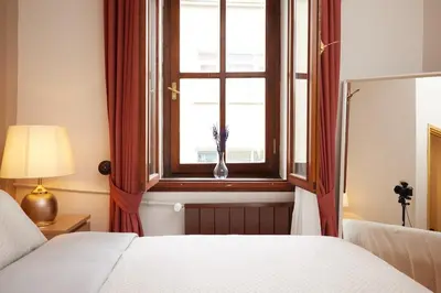a bedroom with a bed and a window with a vase at Taksim Square - Unique Loft for 12 Guests in Istanbul