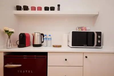 a kitchen counter with a microwave and a toaster oven at Taksim Square - Unique Loft for 12 Guests in Istanbul