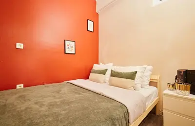 a bed in a room with an orange wall at Stunning 3BR 3Bathroom 3AC near Metro D1 in Istanbul