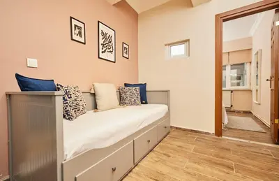 a bedroom with a bed with blue pillows on it at Stunning 3BR 3Bathroom 3AC near Metro D1 in Istanbul