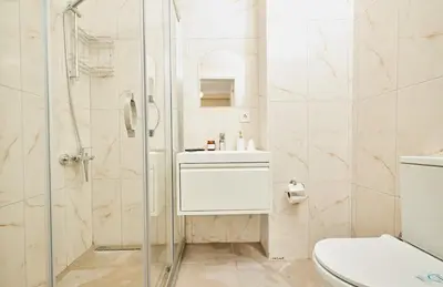 a bathroom with a shower and a toilet and a sink at Stunning 3BR 3Bathroom 3AC near Metro D1 in Istanbul