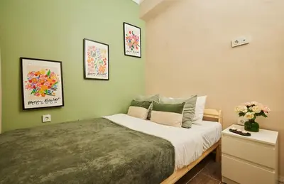 a bedroom with a large bed and some pictures on the wall at Stunning 3BR 3Bathroom 3AC near Metro D2 in Istanbul