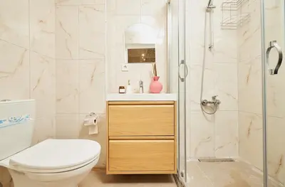 a bathroom with a toilet and a shower at Stunning 3BR 3Bathroom 3AC near Metro D3 in Istanbul