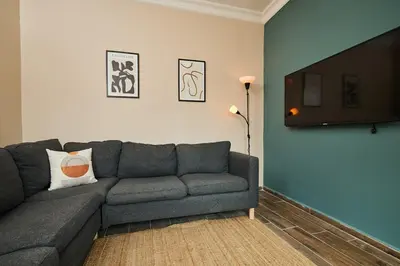 a living room with a couch and a flat screen tv at Stunning 3BR 3Bathroom 3AC near Metro D3 in Istanbul