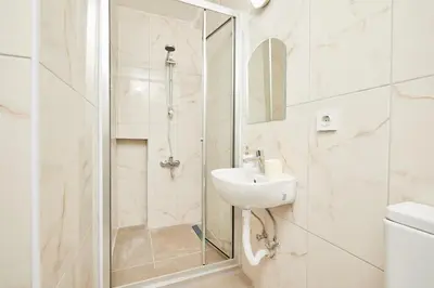 a white bathroom with a sink and a shower at Stunning 3BR 3Bathroom 3AC near Metro D4 in Istanbul