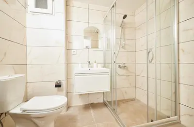 a bathroom with a toilet and a shower at Stunning 3BR 3Bathroom 3AC near Metro D4 in Istanbul