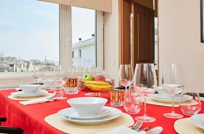 a table with a red table cloth and wine glasses at Stunning 3BR 3Bathroom 3AC near Metro D5 in Istanbul