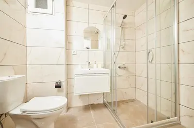 a bathroom with a toilet and a shower at Stunning 3BR 3Bathroom 3AC near Metro D5 in Istanbul