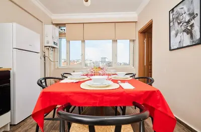 a kitchen with a table with a red table cloth on it at Stunning 3BR 3Bathroom 3AC near Metro D5 in Istanbul