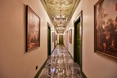 a hallway with paintings on the walls and a ceiling at Emerald Mansion Hotel in Istanbul
