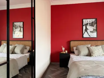 two beds in a room with red walls at Stunning 3BR 3Bathroom 3AC near Metro D6 in Istanbul