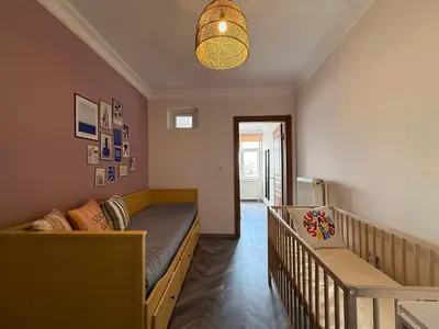 a bedroom with a bed and a crib at Stunning 3BR 3Bathroom 3AC near Metro D6 in Istanbul