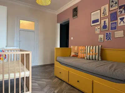 a bedroom with a bed and a crib at Stunning 3BR 3Bathroom 3AC near Metro D6 in Istanbul