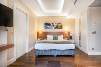 a bedroom with a large bed and a flat screen tv at Veyron Hotels & SPA in Istanbul
