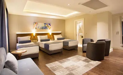 a hotel room with two beds and a couch at Veyron Hotels & SPA in Istanbul