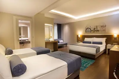 a hotel room with two beds and a couch at Veyron Hotels & SPA in Istanbul