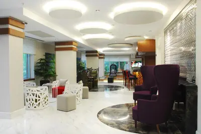 a lobby with chairs and tables in a building at Veyron Hotels & SPA in Istanbul