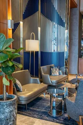 a lobby with two chairs and a table at Delta Hotels by Marriott Istanbul Levent in Istanbul
