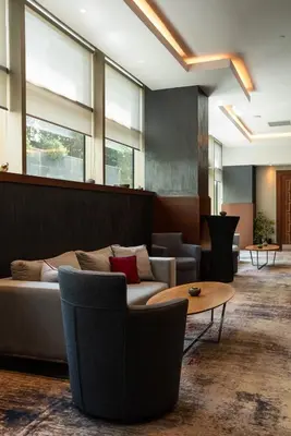 a lobby with a couch and chairs and a table at Delta Hotels by Marriott Istanbul Levent in Istanbul