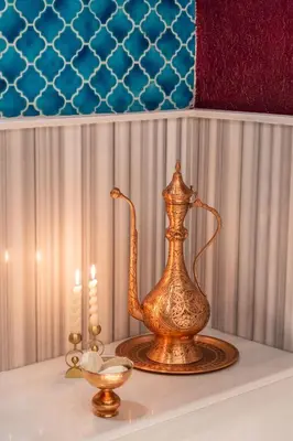 a table with a tea kettle and two candles at Delta Hotels by Marriott Istanbul Levent in Istanbul