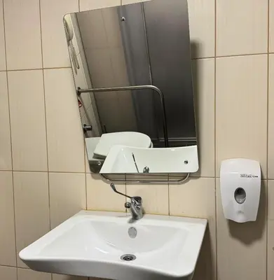 a bathroom sink with a mirror and a soap dispenser at Nidya Hotel Esenyurt in Istanbul