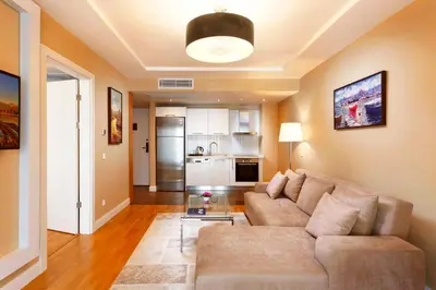 a living room with a couch and a table at Nidya Hotel Esenyurt in Istanbul