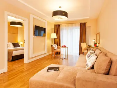 a living room with a couch and a bed at Nidya Hotel Esenyurt in Istanbul
