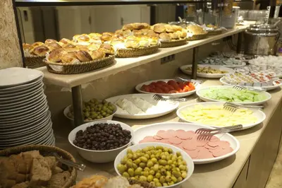 a buffet filled with different types of food on plates at Grand Laleli Hotel in Istanbul