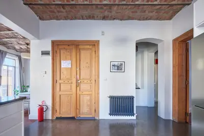 a kitchen with a wooden door and a radiator at Beautiful restored historical apartment in Galata in Istanbul