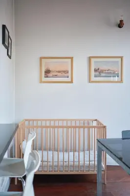 a crib in a room with two pictures on the wall at Beautiful restored historical apartment in Galata in Istanbul