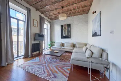 a living room with a couch and a table at Beautiful restored historical apartment in Galata in Istanbul