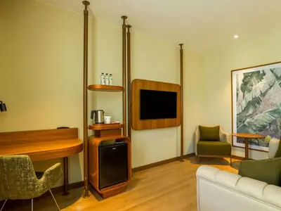 a living room with a tv and a couch and a chair at ibis Styles Istanbul Kurtkoy in Istanbul