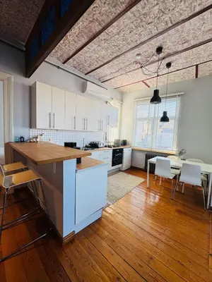 a kitchen with white cabinets and a table and chairs at 3BR,Charming Flat,Golden Horn View in Istanbul