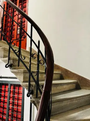 a wooden staircase with a spiralsteel railing in a building at 3BR,Charming Flat,Golden Horn View in Istanbul
