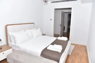 a white bed with two towels on top of it at Yakut Suite in Istanbul