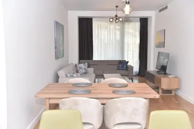 a living room with a wooden table and chairs at Yakut Suite in Istanbul