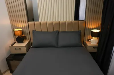 a bedroom with a bed with two night stands and two lamps at World Yours Luxury Suite - Beyoğlu in Istanbul