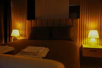 a bedroom with a bed with two lamps on it at World Yours Luxury Suite - Beyoğlu in Istanbul