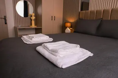 two white towels are sitting on a bed at World Yours Luxury Suite - Beyoğlu in Istanbul