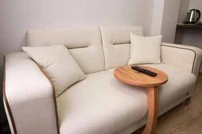 a white couch with a remote control on a table at World Yours Luxury Suite - Beyoğlu in Istanbul