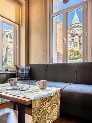a living room with a couch and a table at Classic Historical Galata Apartment in Istanbul