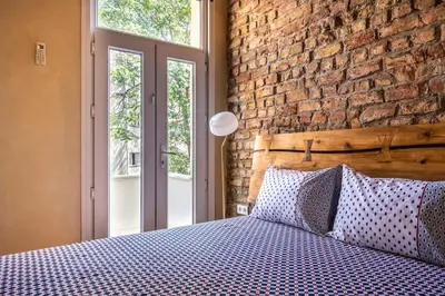 a bedroom with a brick wall and a bed with pillows at Classic Historical Galata Apartment in Istanbul