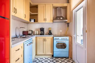 a small kitchen with a blue stove and cabinets at Classic Historical Galata Apartment in Istanbul