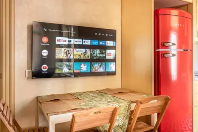 a table and a red refrigerator in a room at Classic Historical Galata Apartment in Istanbul
