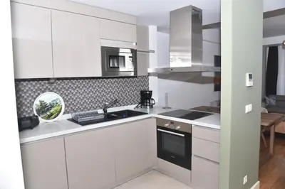 a white kitchen with a sink and a stove at Sedef Suite in Istanbul