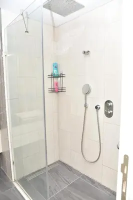 a bathroom with a shower with a glass door at Sedef Suite in Istanbul