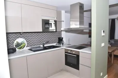 a white kitchen with a sink and a stove at Sedef Suite in Istanbul