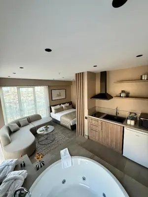 a bathroom with a bath tub and a bedroom at Cityloft 147 in Istanbul