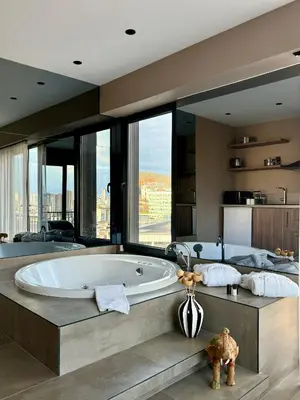 a large bathroom with a tub and large windows at Cityloft 147 in Istanbul