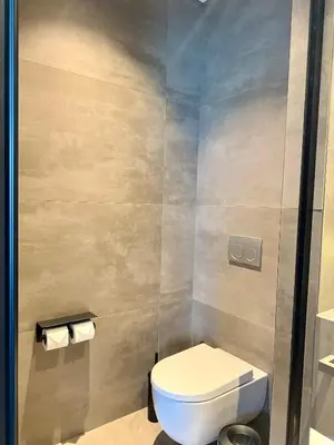 a bathroom with a toilet and two rolls of toilet paper at Cityloft 147 in Istanbul
